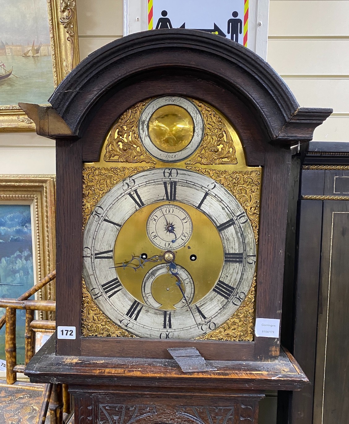 An 18th century oak 8 day longcase clock, with later carved decoration, the silvered chapter ring with Arabic and black Roman numerals with seconds dial and further subsidiary dial engraved Burroughs, Fordham, (requiring